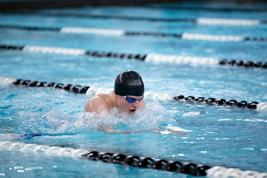 high school swimmer practicing breaststroke in the pool