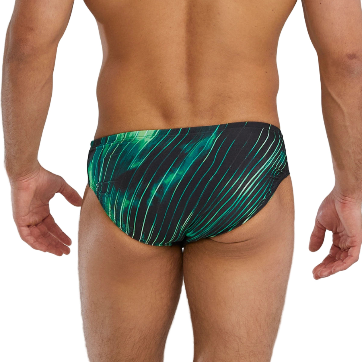 Green and black patterned swim briefs worn by a person on a gray background